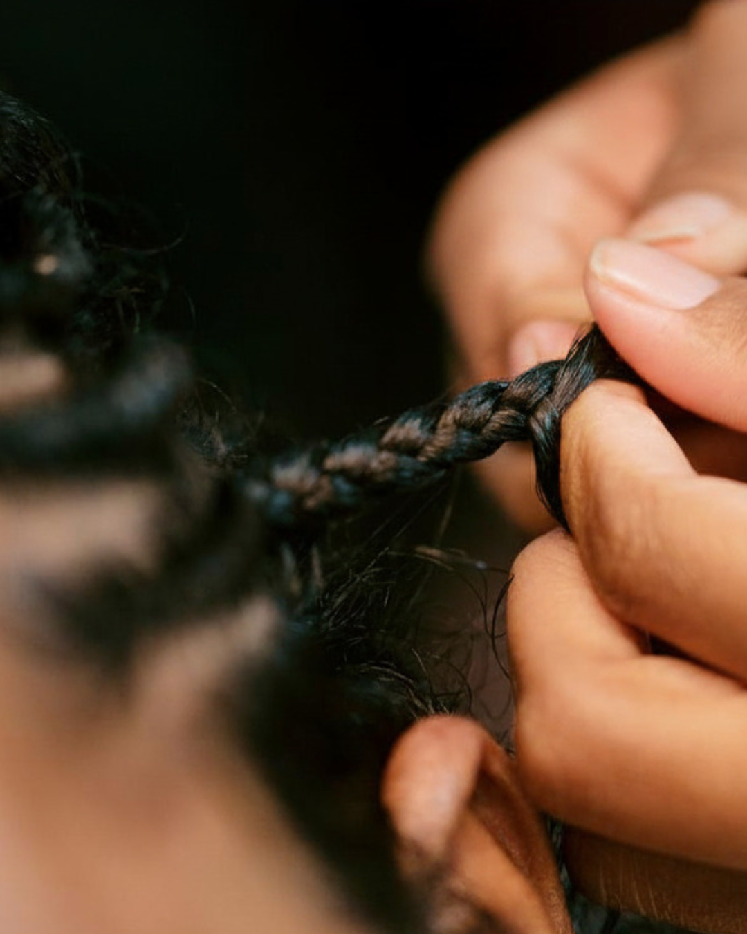 Barber carefully removing men's braids